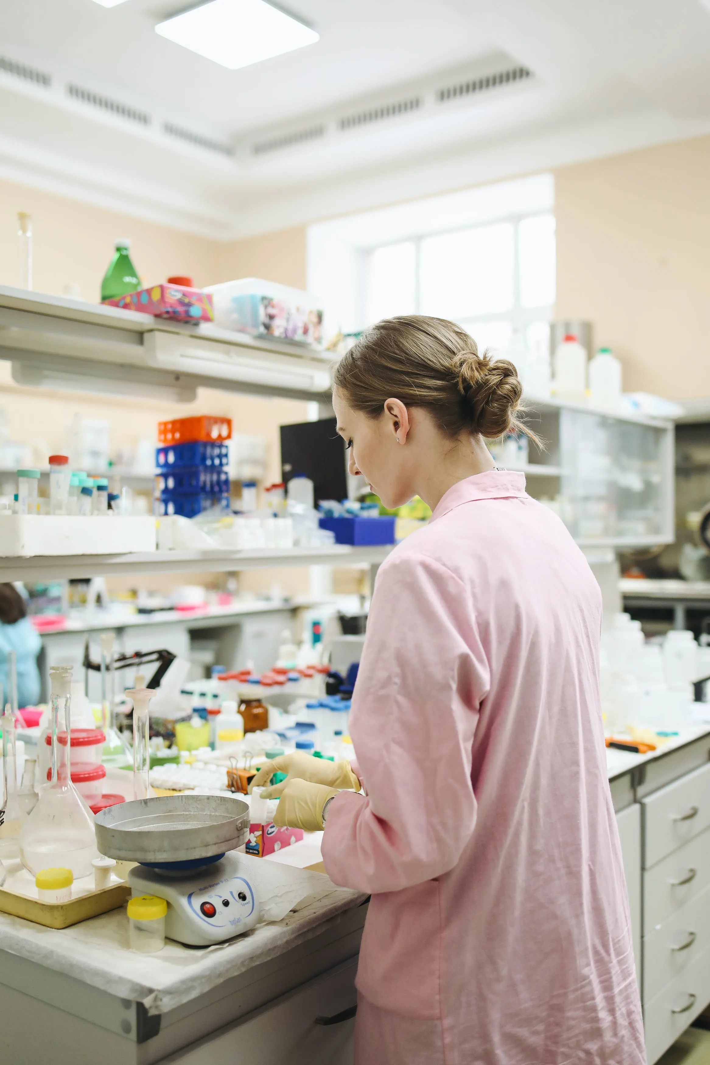 A woman preparing some medicine in a lab